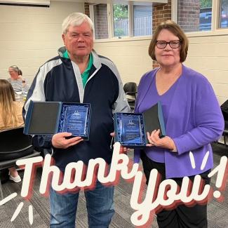 A man and a woman holding crystal books. Superimposed text reading "Thank you!"